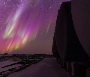 Purple, yellow and gree aurora over station