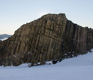 Large rock formations jutting out of the sea ice