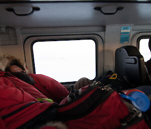 Expeditioner asleep on the back seat of a hagglunds