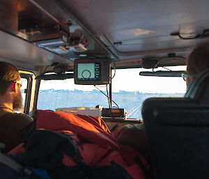 Photo taken from within the hagglund cabin aimed at a driver and passenger
