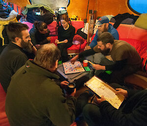 Eight expeditioners in a small hut all playing scrabble