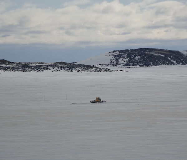 Groomer on the sea ice on driving along a cleared section of the ice