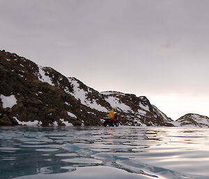 Expeditioner on a quad bike on a frozen lake