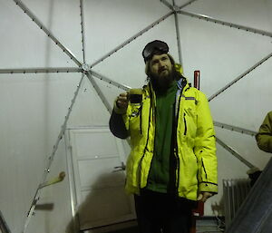 Expeditioner dressed in yellow jacket inside a large dome