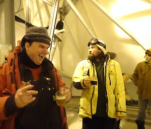 Two expeditioners having a beer in a large dome