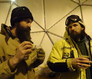 Two expeditioners having a beer in a large dome