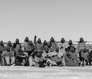 The 2014 winter expeditioners sit on lounges on the sea ice, all wearing beards