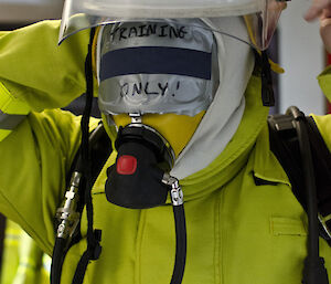 Close up of expeditioner wearing mask and firefighting helmet