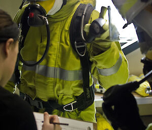 Breathing Apparatus Control person with clipboard checking expeditioner is wearing fire clothing correctly