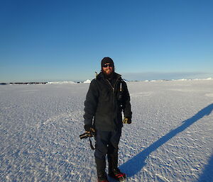 Expeditioner standing on sea ice