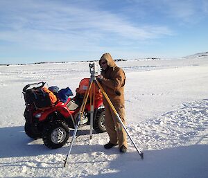 Expeditioner with surveying equipment on the sea ice