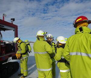 Expeditioners dressed in fire fighting clothes