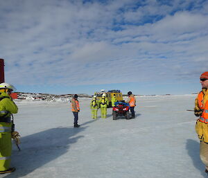 Expeditioners dressed in fire fighting kit on the sea ice