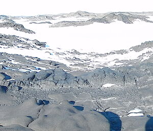 Photo of four expeditioners in the distance standing on Barrier Island