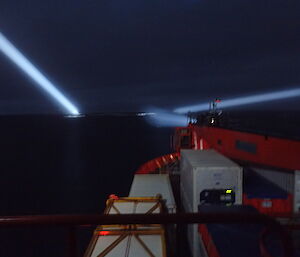 Late night photo taken from the Aurora Australis spotlights on icebergs