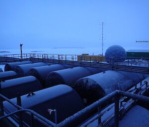 Fuel tanks, satelite dome and sea ice in the background