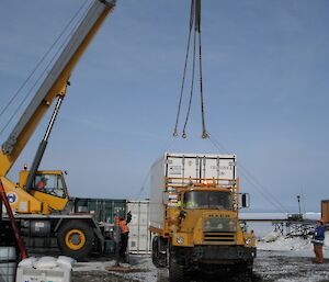 Containers unloaded by crane outside the supply store