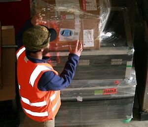 Storeperson unpacking Mawson bound cargo