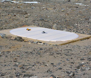 Wooden base for huts sitting on rock surface