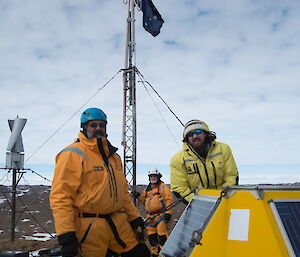 Three expeditioners facing camera on ridgeline