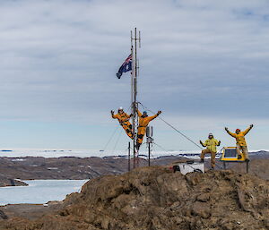 Four expeditioners facing camera standing on ridgeline
