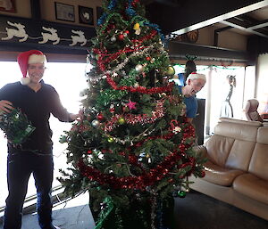 Expeditioners stringing up Christmas decorations