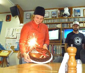 Belinda and her birthday cake, decorated with a picture of her using a fire hose