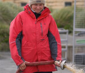 Jaimie, not impressed by the dribble of muddy water comming out of her fire hose.