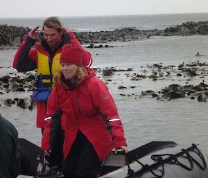 and welcome to Robbie and Lisa! Tow new expeditioners walk up the beach.