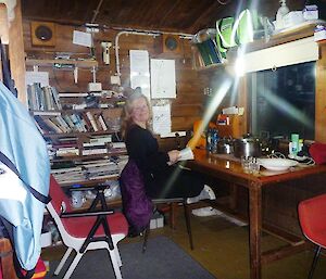 Lisa relaxing in Green Gorge hut — out of the wind and the rain!