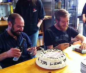 Leon and Tim celebrate a Happy Birthday with a cake.