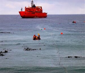 Refueling, with the fuel line prepared and monitored by boats