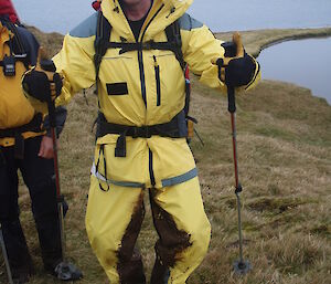 Expeditioner with mud all over legs after hiking