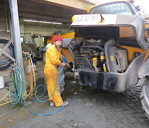 Expedition mechanic working outside on large vehicle