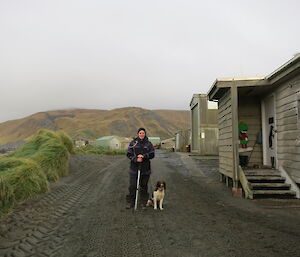 Dana and Joker (dog) beside a hut