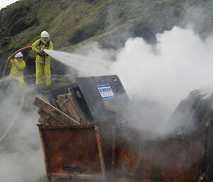 two xpeditioners putting out a fire