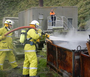 Expeditioners putting out a fire