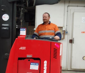 Matt and his second job, the Storeman, driving a red forklift