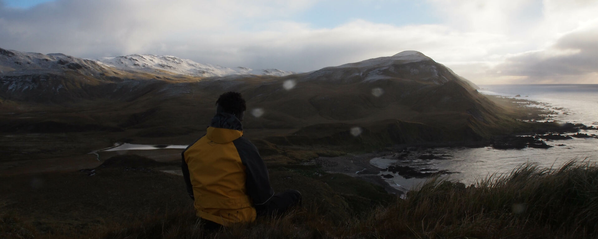 Expeditioner looking out to the horizon and water from Macquarie Island