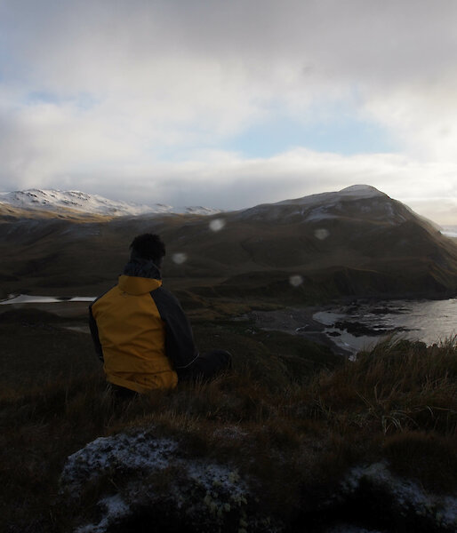 Expeditioner looking out to the horizon and water from Macquarie Island