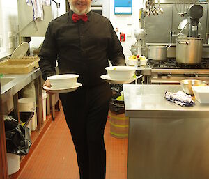 Jum, Saturday night’s waiter, with black shirt and pants, red bow tie and carrying two bowls of soup