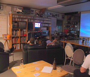 Expeditioners watch the State of Origin game on a very small television