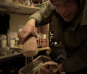 Kelly baking bread in the hut