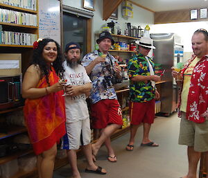 Mel, Robby, Tom, Jim, Matt pose in Hawaiian clothing and with drinks