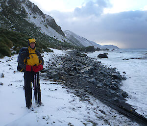 Richard poses with mountain to left of shot and snowy landscape to right