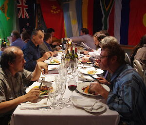 Expeditioners chat over dinner at Macca 2012 Midwinter dinner