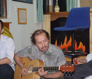 Robby playing guitar at Macca for Midwinters celebrations