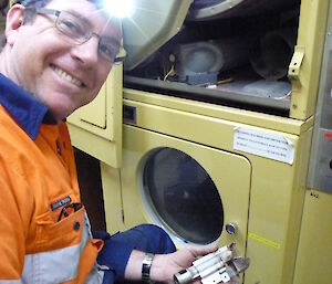 Tom repairing one of the clothes dryers