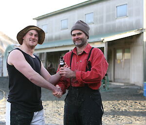 Kiwi team Leader Jack accepting the trophy from Aussie Stu