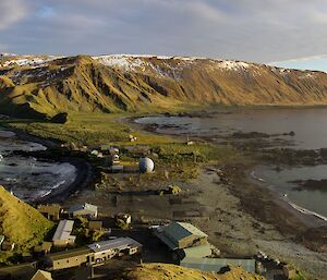 Station on isthmus and Plateau bathed in golden afternoon sun in a view taken from on top of North Head